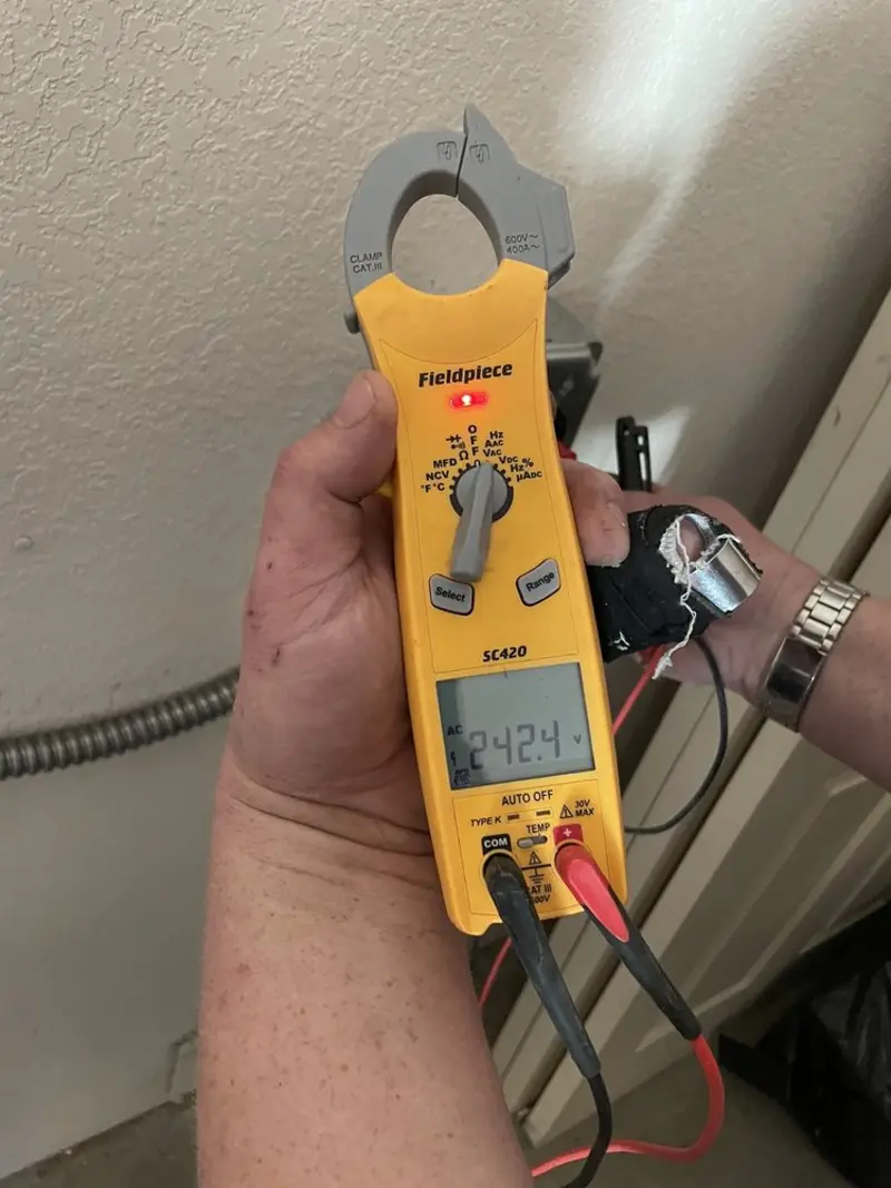 Voltage testing with clamp meter during Electrical Installation Services in Tishomingo